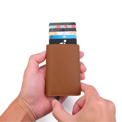 Man holding a modern aluminum RFID card holder wallet with an integrated money clip.